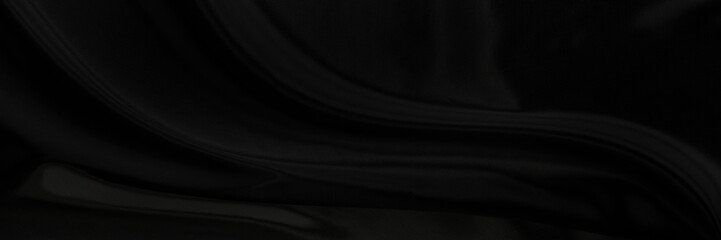 Black gray satin dark fabric texture luxurious shiny that is abstract silk cloth panorama background with patterns soft waves blur beautiful.