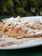 Almond Croissant Delight Flaky Pastry with Powdered Sugar and Almonds