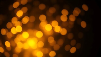 Fototapeta premium Dreamy golden bokeh sparkles on a dark background creating an atmospheric glowing effect.