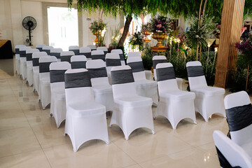white chairs neatly arranged at the wedding reception
