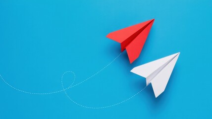 Leadership concept with red paper airplane flying ahead