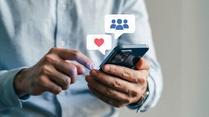 Man interacting with smartphone receiving social media engagement notifications like hearts and people icons