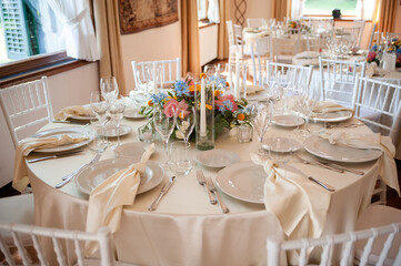 Elegant wedding reception table setup with floral centerpiece