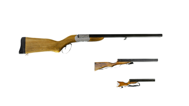 Old traditional black powder rifle Three decorative shotguns with black metal barrels, wooden combs and grips decorated with engravures on a silver colored metallic band. Isolated in white background.