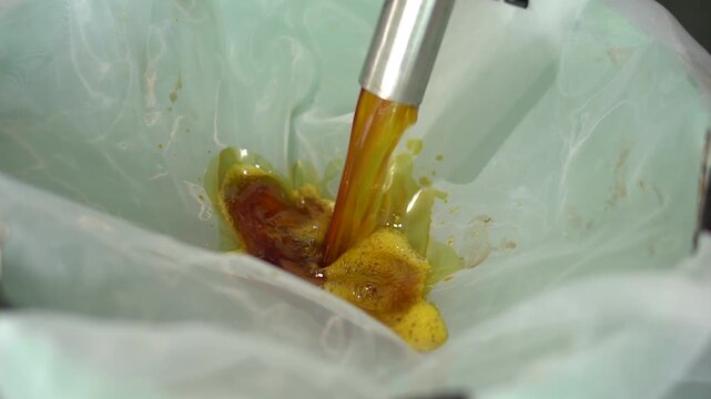 Footage of the patchouli oil distillation process in a rural facility, showing traditional and semi-modern equipment used to extract essential oils from dried patchouli leaves