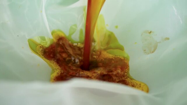 Footage of the patchouli oil distillation process in a rural facility, showing traditional and semi-modern equipment used to extract essential oils from dried patchouli leaves