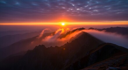 Golden Sunrise Ignites Swirling Clouds Above a Majestic Mountain Range