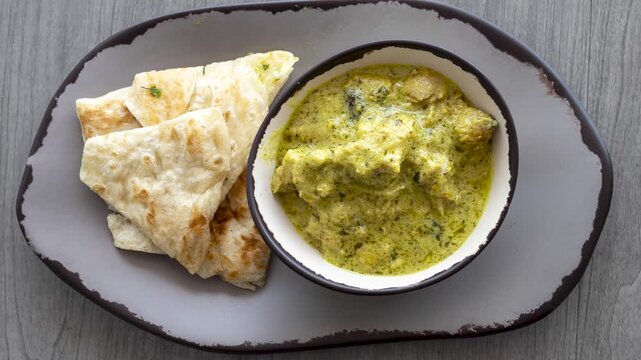 Rotating a Dish of Indian Korma Coconut Curry and Naan