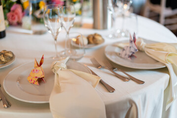 Elegant table setting with origami rabbits at wedding reception