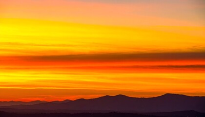Obraz premium Vivid sunset over hazy mountains