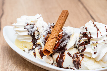 Ice cream with whipped cream and chocolate sauce topping in La Louvière, Hainaut, Belgium