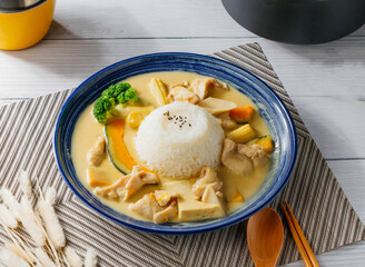 Creamy Thai Green Curry Chicken with Coconut Milk, Vegetables, and Jasmine Rice in bowl side view of taiwan food