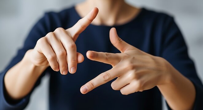 Close up on a person's hands forming American Sign Language ASL alphabet letter U showing clear communication and inclusive language understanding