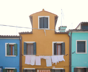 Colorful Burano houses with laundry hanging outside