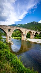 Ancient stone arch bridge over river