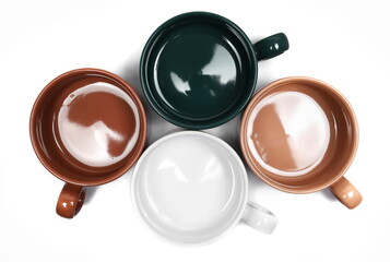 Group colorful coffee mugs isolated on white background, top view, clipping path