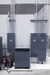 High voltage electrical panels and tubes on warehouse wall