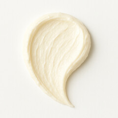 High-resolution close-up of a thick, teardrop-shaped smear of organic cream on a white background. Perfect for showcasing clean beauty, eco-friendly skincare