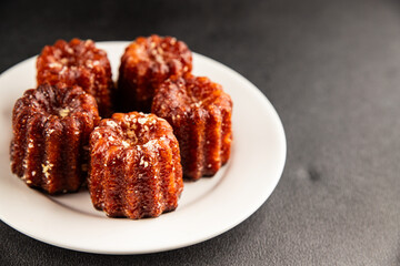 Canneles sweet dessert french cuisine sweets fresh delicious gourmet food background on the table rustic food top view copy space