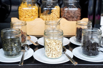 Jars with oatmeal and jam at breakfast