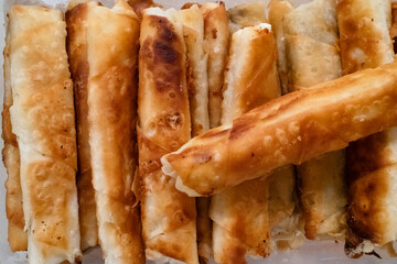 Crispy, golden-brown rolls filled with savory ingredients, arranged neatly on a plate, perfect for appetizers or snacks