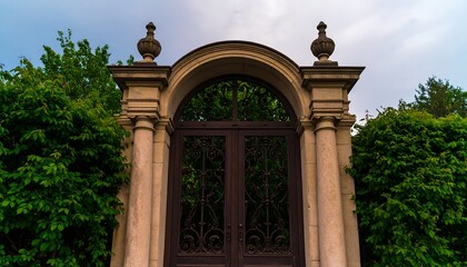 Fototapeta premium Ornate arched gate in lush garden setting
