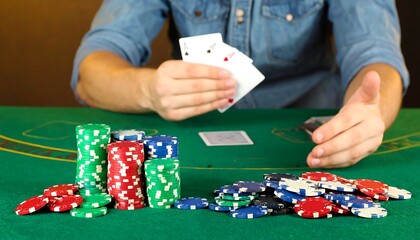 Poker player holding cards at a green table
