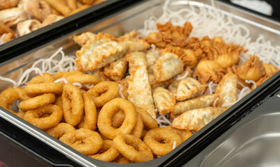 Deep fry seafood set with calamari rings, crispy gyoza dumplings, shrimps and spring rolls