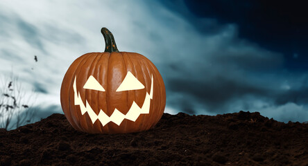 A Jack O' Lantern pumpkin on the ground on Halloween night