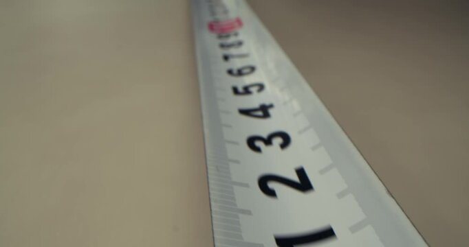 Tape measure close-up. The measuring tape macro, camera moves up, shooting with slider.