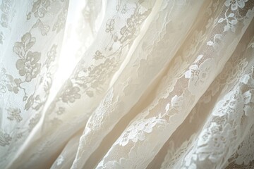 Obraz premium Elegant ivory lace fabric drapes softly with floral patterns, creating a delicate and textured background.