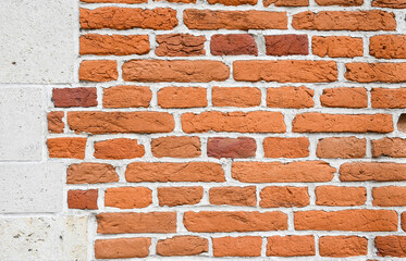 Obraz premium Traditional Flemish orange brick wall with alternating stretcher and header courses in each course, The rough texture of the red clay brick contrasts beautifully with the bright white mortar,