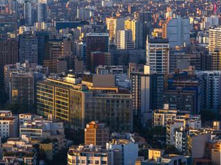 Fototapeta premium Sunset view of high-rise buildings in Miraflores, Lima, Peru, highlighting dense urban architecture with vertical structures and countless windows.
