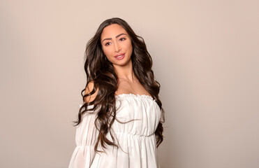 Fototapeta premium Beautiful young woman with long black shiny hair 