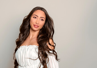 Fototapeta premium Beautiful young woman with long black shiny hair 