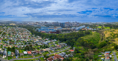 Drone aerial panoramic photograph of the Port Kembla steel works and surrounding residential suburbs in the Illawarra region on the south coast of New South Wales, Australia. 
