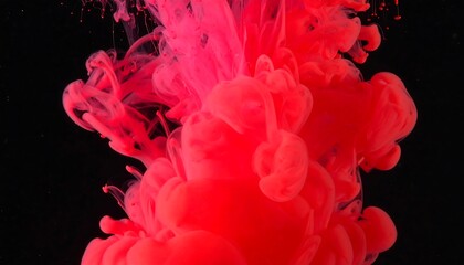 Vibrant red ink swirling in dark liquid