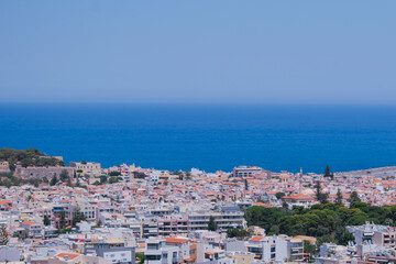 Naklejka premium Panoramic view of the Greek city of Rethymno from a height on the island of Crete Greece. Residential buildings and the Aegean sea
