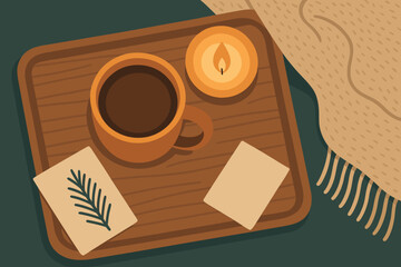 Cozy coffee break on a wooden tray with a candle and botanical elements in a warm setting