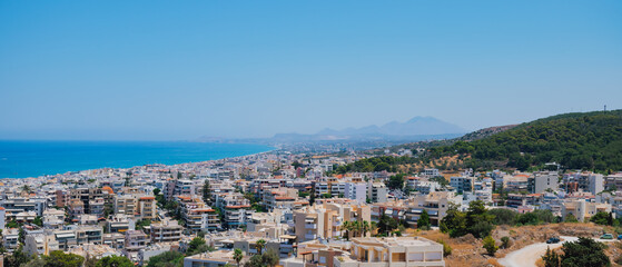 Naklejka premium Panoramic view of the Greek city of Rethymno from a height on the island of Crete Greece. Residential buildings and the Aegean sea