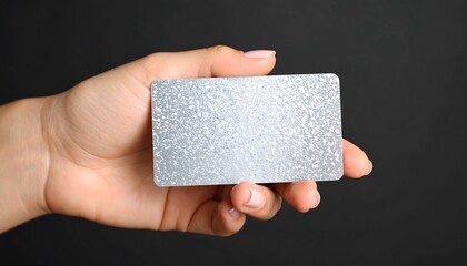 Blank silver card held by hand