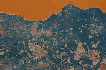 Old peeled paint on wall orange and dark blue