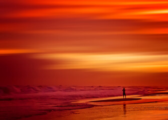 Person silhouetted at sunset on Pensacola Beach in Pensacola Florida, Florida Panhandle travel destinations