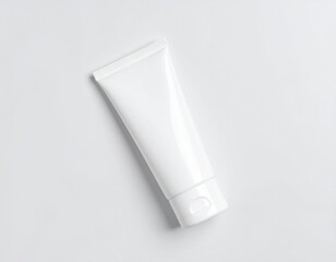 Blank white plastic tube for cosmetic cream or gel. Top view flat lay mockup for skincare product packaging design.