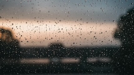 Raindrops on a window at sunset - Powered by Adobe