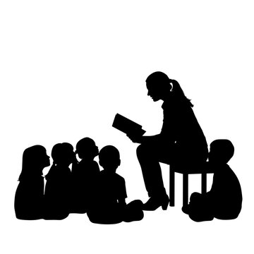 A teacher reading a book to a group of children sitting and listening attentively in silhouette form