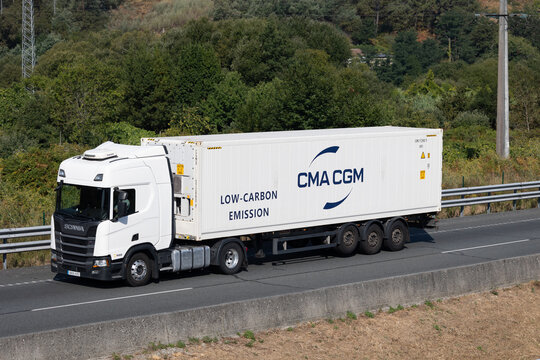 Pontevedra, spain 08 08 2025 white scania truck carrying cma cgm low-carbon emission container on highway