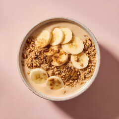 Chai smoothie bowl with banana slices granola and cinnamon sprinkle