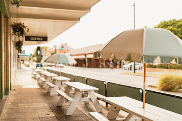 Picnic tables with beach umbrellas lined up outside Newcastle pub
