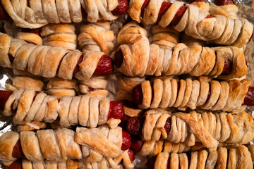 Bite-sized sausages wrapped in flaky pastry, golden brown and savory, perfect for halloween parties and snacks